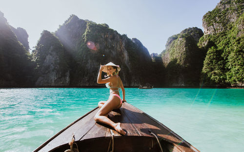 Woman on longtail boat in sea