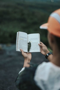 Midsection of man holding book