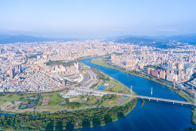 High angle view of river amidst buildings in city against sky