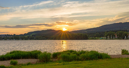 Scenic view of lake against sky during sunset