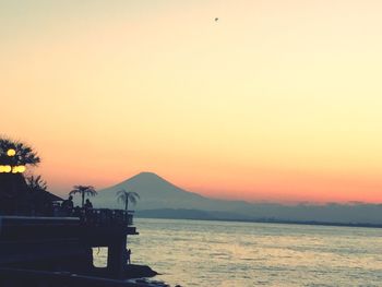 Scenic view of sea against orange sky