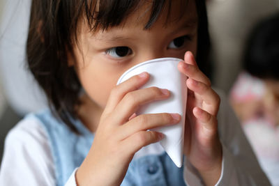 Close-up portrait of boy drinking water