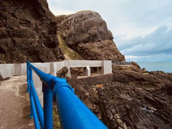 Rock formations by sea against sky