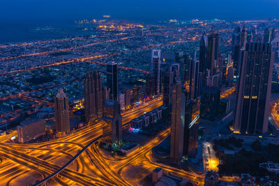 Aerial view of illuminated buildings in city at night