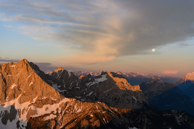 Scenic view of snowcapped mountains against sky during sunset