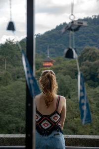 Rear view of woman looking away from camera into the mountains