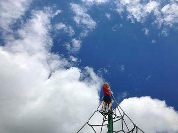 Low angle view of person standing against sky