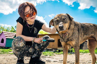 Dog at the shelter. animal shelter volunteer takes care of dogs. lonely dogs in cage with volunteer.