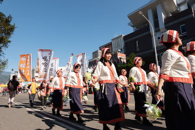 Group of people in front of buildings