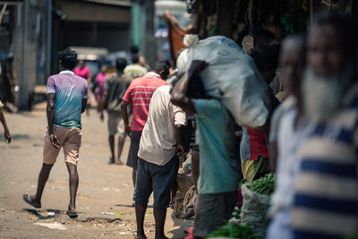 Rear view of people walking on street