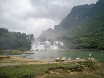 Scenic view of lake against cloudy sky