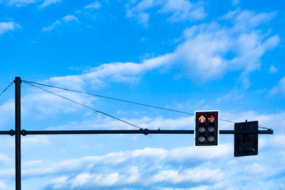 Low angle view of road signal against blue sky