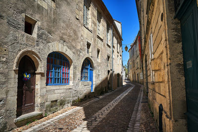 Street amidst buildings against sky