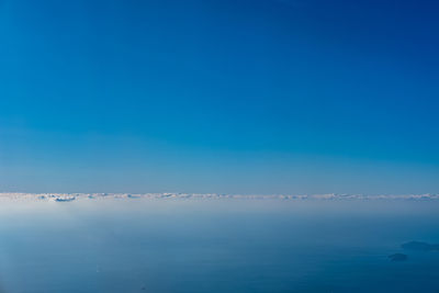 Scenic view of sea against clear blue sky