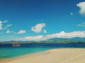Scenic view of sea against blue sky