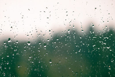 Full frame shot of wet glass window during rainy season