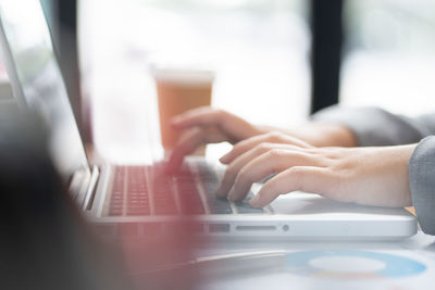 Midsection of woman using laptop