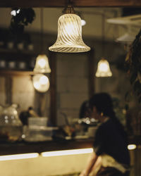 Illuminated pendant lights hanging in restaurant