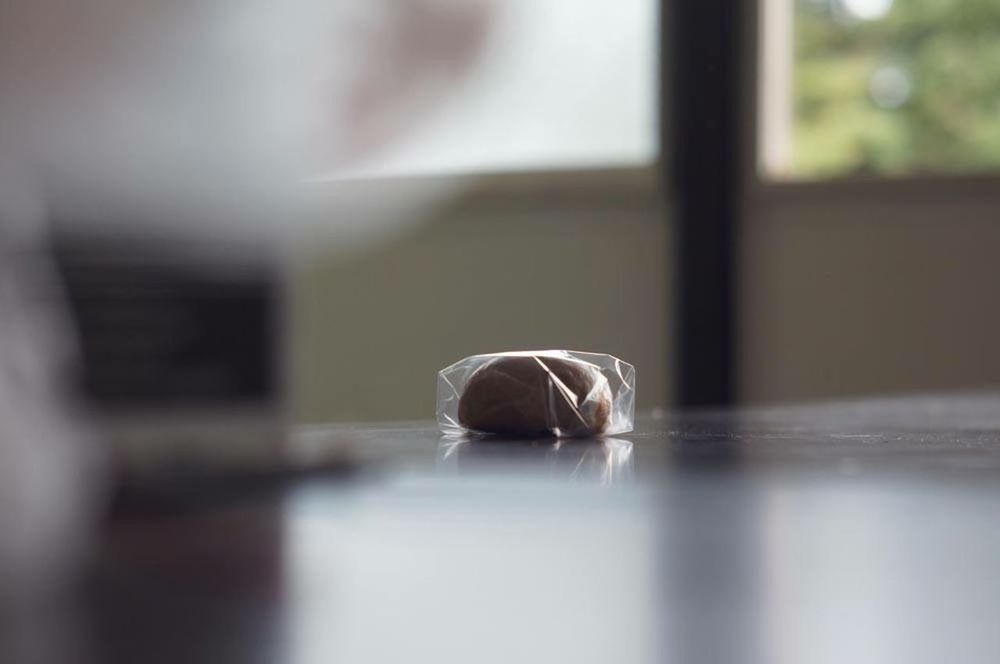 indoors, selective focus, table, close-up, still life, focus on foreground, home interior, glass - material, no people, wood - material, window, empty, surface level, wall - building feature, flooring, reflection, day, transparent, absence, single object