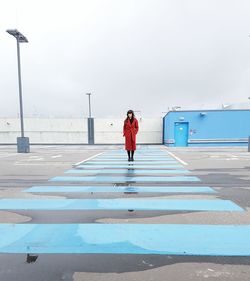 Rear view of woman standing on road