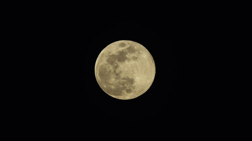 Low angle view of full moon against sky at night