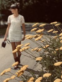 Young woman in white dress walking 