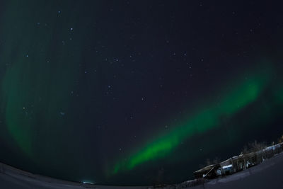 Low angle view of snow against sky at night