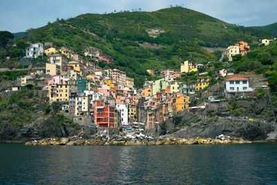 Scenic view of town by sea