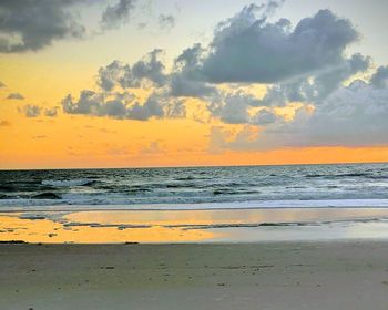 Scenic view of beach against sky during sunset