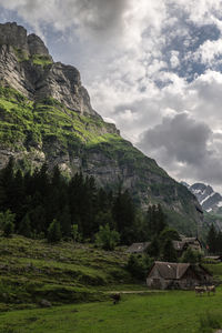 Scenic view of mountains against cloudy sky