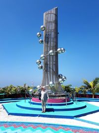 Statue of swimming pool against blue sky