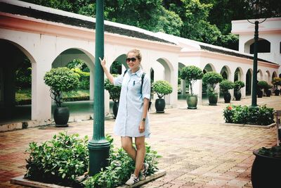 Woman standing against plants