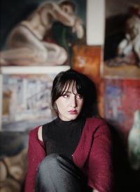 Portrait of young woman sitting outdoors