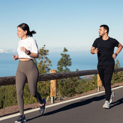 Full length of couple jogging outdoors