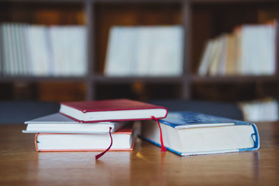 Close-up of books on wooden table at library