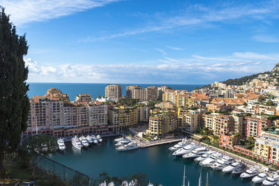 High angle view of bay and buildings against sky