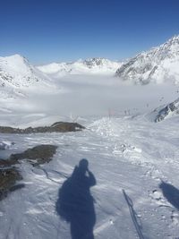 People skiing on snowcapped mountain against sky