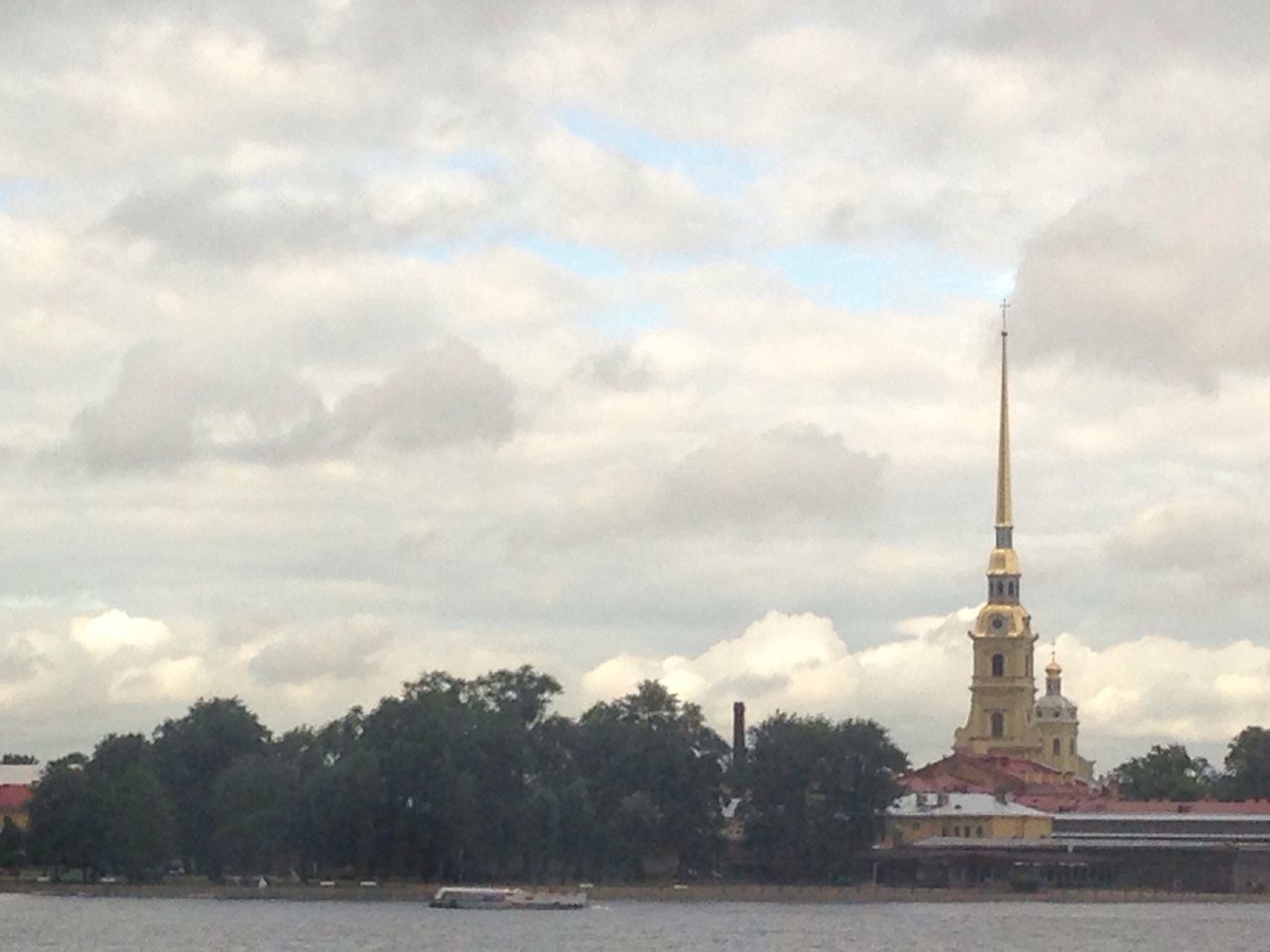 sky, cloud - sky, cloudy, built structure, architecture, building exterior, water, tree, weather, cloud, overcast, river, tower, day, nature, religion, outdoors, travel destinations, street light, waterfront