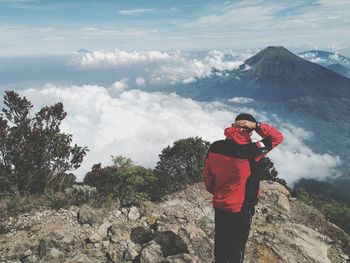 Man standing on mountain against sky