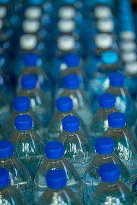 A vertical shot of plastic bottles of water in rows