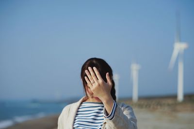 Portrait of woman standing against sky