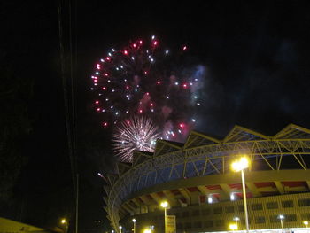 Low angle view of firework display at night