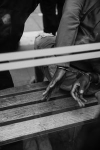 Midsection of man in handcuffs