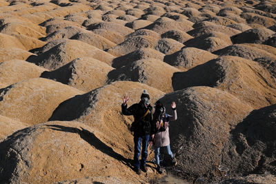 Shadow of man photographing on rock