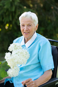 Portrait of young woman holding bouquet