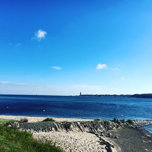 Scenic view of sea against blue sky