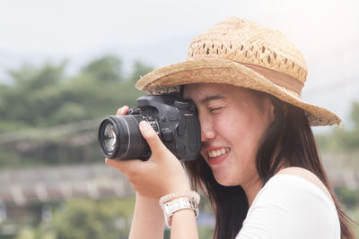 Portrait of woman photographing camera