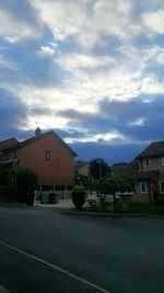 Buildings against cloudy sky