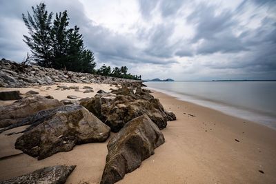 Rocks on beach against sky