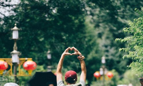 Rear view of man gesturing at park